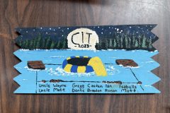 CIT plaque from 2023 at Camp Hinds. They stayed in Wilderness. Located in the dining hall.