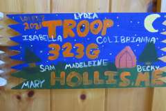 Troop 323 plaque from 2021 at Camp Hinds. They are from Hollis. Located in the dining hall.