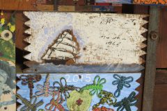 Unknown plaque from 1965. Located in the middle rafters of bay 1.