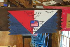 Troop 322 plaque from 2015 at Camp Hinds. They are from Tewksbury, MA and stayed in Maguire. Located in the middle rafters of bay 1 of Ring Hall.